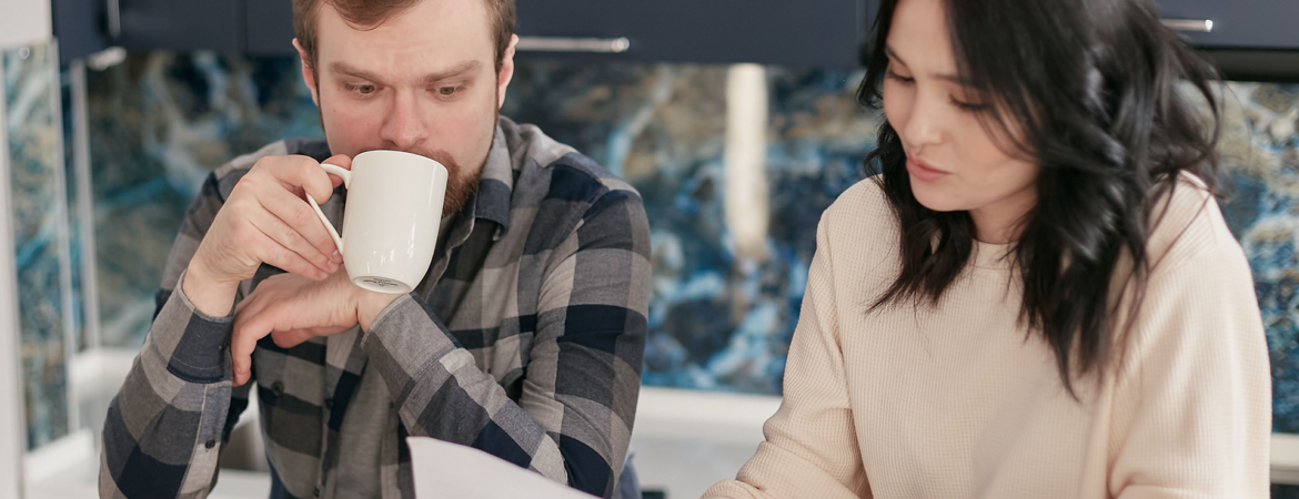 Couple researching debt settlement companies.